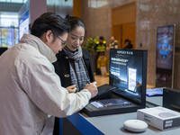 A visitor tries out a handwritten translation system at the 2024 Global Artificial Intelligence Product Application Expo in Suzhou, China, o...