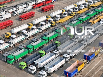 A large number of trucks and construction machinery gather at Yantai Port to be loaded for export in Yantai, Shandong province, China, on De...