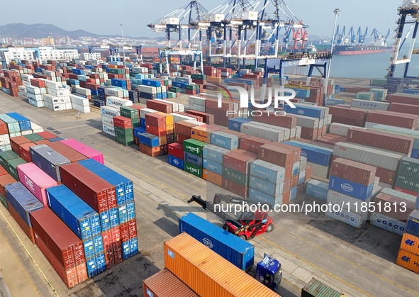 The photo shows the working scene of the International container terminal of Yantai Port, a port in Shandong province, China, on December 10...