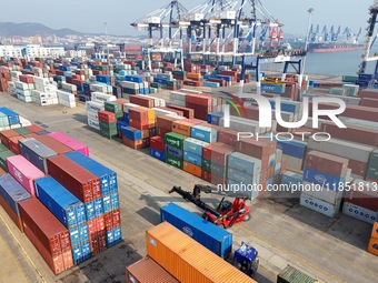 The photo shows the working scene of the International container terminal of Yantai Port, a port in Shandong province, China, on December 10...