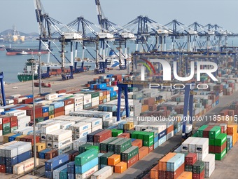 The photo shows the working scene of the International container terminal of Yantai Port, a port in Shandong province, China, on December 10...