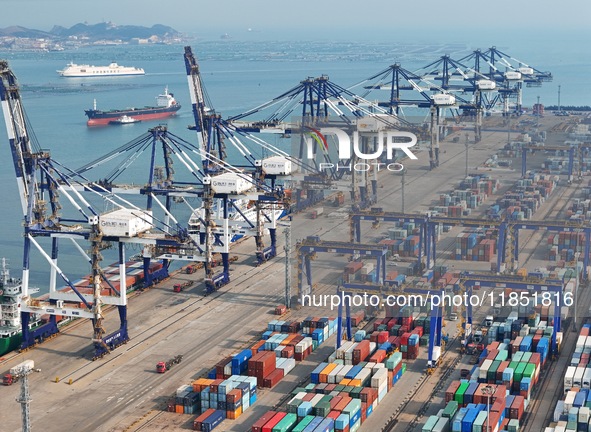 The photo shows the working scene of the International container terminal of Yantai Port, a port in Shandong province, China, on December 10...