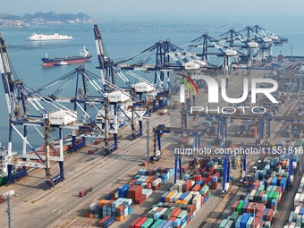 The photo shows the working scene of the International container terminal of Yantai Port, a port in Shandong province, China, on December 10...