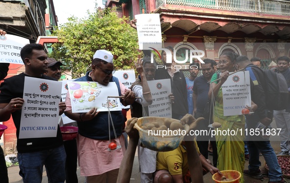 Supporters of the Indian National Congress take part in a protest against the price hike of vegetables in Kolkata, India, on December 10, 20...