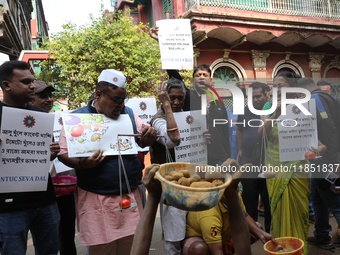 Supporters of the Indian National Congress take part in a protest against the price hike of vegetables in Kolkata, India, on December 10, 20...