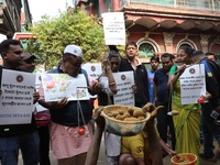 Supporters of the Indian National Congress take part in a protest against the price hike of vegetables in Kolkata, India, on December 10, 20...