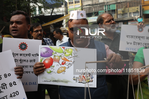 Supporters of the Indian National Congress take part in a protest against the price hike of vegetables in Kolkata, India, on December 10, 20...