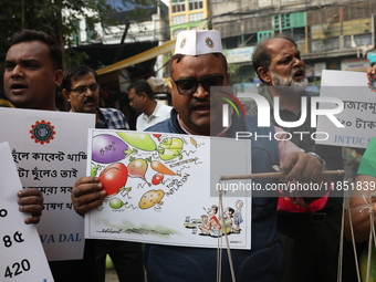 Supporters of the Indian National Congress take part in a protest against the price hike of vegetables in Kolkata, India, on December 10, 20...