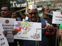 Supporters of the Indian National Congress take part in a protest against the price hike of vegetables in Kolkata, India, on December 10, 20...