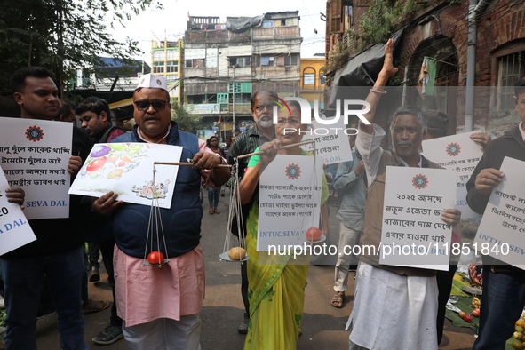 Supporters of the Indian National Congress take part in a protest against the price hike of vegetables in Kolkata, India, on December 10, 20...