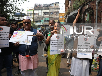 Supporters of the Indian National Congress take part in a protest against the price hike of vegetables in Kolkata, India, on December 10, 20...