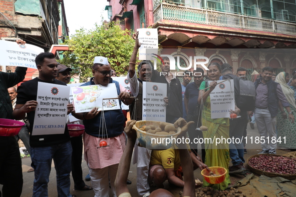 Supporters of the Indian National Congress take part in a protest against the price hike of vegetables in Kolkata, India, on December 10, 20...