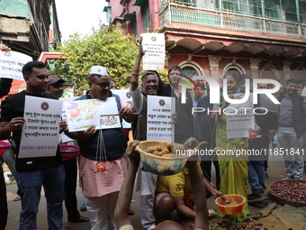 Supporters of the Indian National Congress take part in a protest against the price hike of vegetables in Kolkata, India, on December 10, 20...