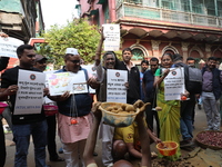 Supporters of the Indian National Congress take part in a protest against the price hike of vegetables in Kolkata, India, on December 10, 20...