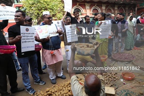 Supporters of the Indian National Congress take part in a protest against the price hike of vegetables in Kolkata, India, on December 10, 20...