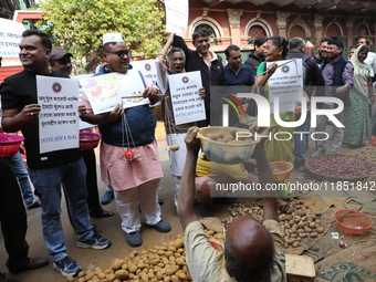 Supporters of the Indian National Congress take part in a protest against the price hike of vegetables in Kolkata, India, on December 10, 20...