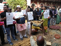 Supporters of the Indian National Congress take part in a protest against the price hike of vegetables in Kolkata, India, on December 10, 20...