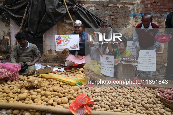 Supporters of the Indian National Congress take part in a protest against the price hike of vegetables in Kolkata, India, on December 10, 20...