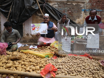 Supporters of the Indian National Congress take part in a protest against the price hike of vegetables in Kolkata, India, on December 10, 20...