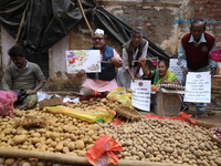 Supporters of the Indian National Congress take part in a protest against the price hike of vegetables in Kolkata, India, on December 10, 20...