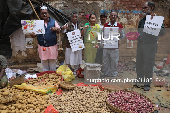 Supporters of the Indian National Congress take part in a protest against the price hike of vegetables in Kolkata, India, on December 10, 20...