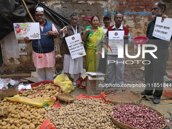 Supporters of the Indian National Congress take part in a protest against the price hike of vegetables in Kolkata, India, on December 10, 20...