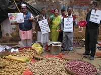 Supporters of the Indian National Congress take part in a protest against the price hike of vegetables in Kolkata, India, on December 10, 20...