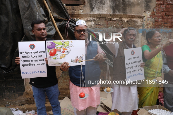 Supporters of the Indian National Congress take part in a protest against the price hike of vegetables in Kolkata, India, on December 10, 20...