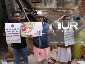 Supporters of the Indian National Congress take part in a protest against the price hike of vegetables in Kolkata, India, on December 10, 20...