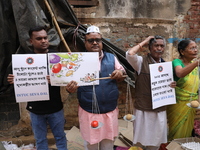 Supporters of the Indian National Congress take part in a protest against the price hike of vegetables in Kolkata, India, on December 10, 20...