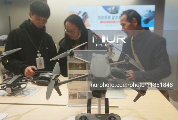 Customers shop for a new aerial drone at a DJI store in Hangzhou, China, on December 10, 2024. 