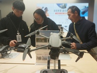 Customers shop for a new aerial drone at a DJI store in Hangzhou, China, on December 10, 2024. (