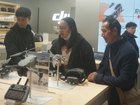 Customers shop for a new aerial drone at a DJI store in Hangzhou, China, on December 10, 2024. (