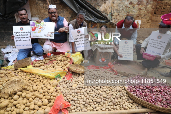 Supporters of the Indian National Congress take part in a protest against the price hike of vegetables in Kolkata, India, on December 10, 20...