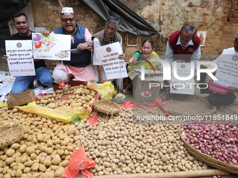 Supporters of the Indian National Congress take part in a protest against the price hike of vegetables in Kolkata, India, on December 10, 20...