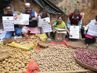 Supporters of the Indian National Congress take part in a protest against the price hike of vegetables in Kolkata, India, on December 10, 20...