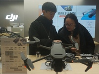 Customers shop for a new aerial drone at a DJI store in Hangzhou, China, on December 10, 2024. (