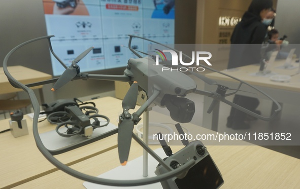 Customers shop for a new aerial drone at a DJI store in Hangzhou, China, on December 10, 2024. 