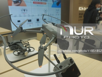 Customers shop for a new aerial drone at a DJI store in Hangzhou, China, on December 10, 2024. (