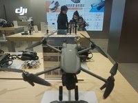 Customers shop for a new aerial drone at a DJI store in Hangzhou, China, on December 10, 2024. (