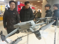 Customers shop for a new aerial drone at a DJI store in Hangzhou, China, on December 10, 2024. (