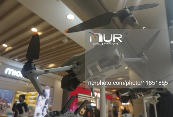 Customers shop for a new aerial drone at a DJI store in Hangzhou, China, on December 10, 2024. 