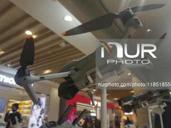 Customers shop for a new aerial drone at a DJI store in Hangzhou, China, on December 10, 2024. (