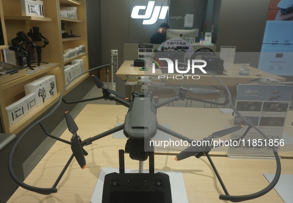 Customers shop for a new aerial drone at a DJI store in Hangzhou, China, on December 10, 2024. 