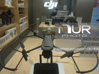 Customers shop for a new aerial drone at a DJI store in Hangzhou, China, on December 10, 2024. (