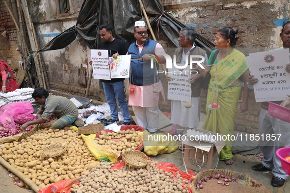 Supporters of the Indian National Congress take part in a protest against the price hike of vegetables in Kolkata, India, on December 10, 20...