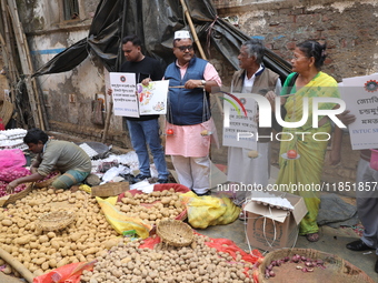 Supporters of the Indian National Congress take part in a protest against the price hike of vegetables in Kolkata, India, on December 10, 20...