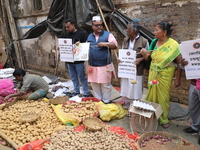 Supporters of the Indian National Congress take part in a protest against the price hike of vegetables in Kolkata, India, on December 10, 20...