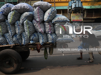 Labourers transport garlic sacks in a handcart at a wholesale market before moving them to a retail market in Kolkata, India, on December 10...