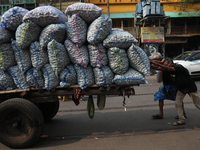 Labourers transport garlic sacks in a handcart at a wholesale market before moving them to a retail market in Kolkata, India, on December 10...